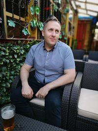 Thoughtful man sitting on chair in restaurant