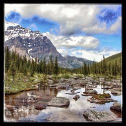 Scenic view of mountains against cloudy sky