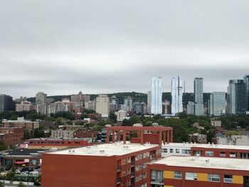 High angle view of buildings in city against sky