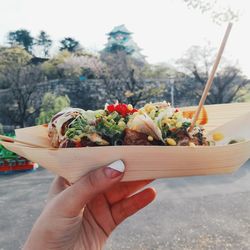 Cropped image of woman holding food