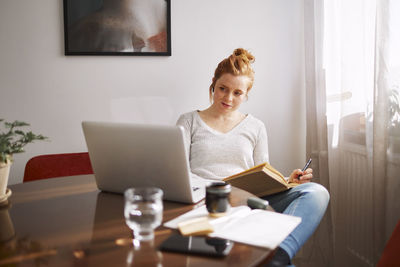 Woman using laptop at home