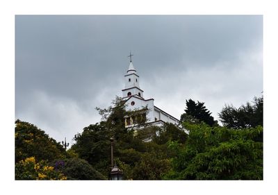 Panoramic view of trees and buildings against sky