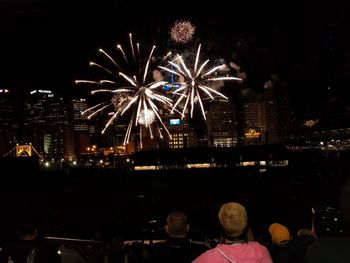 Firework display in city at night