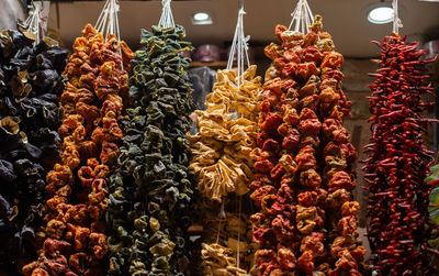 Bundles of sun dried vegetables hanging up at turkish bazaar