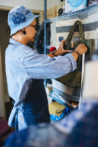 Man working over fabric on table