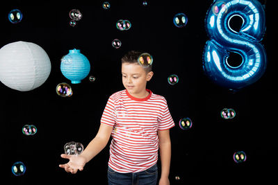 Full length of boy standing at night