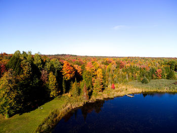 Scenic view of lake against clear blue sky