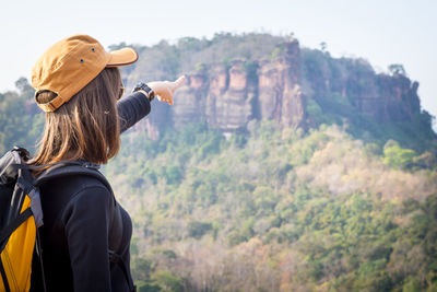Rear view of man standing against mountain