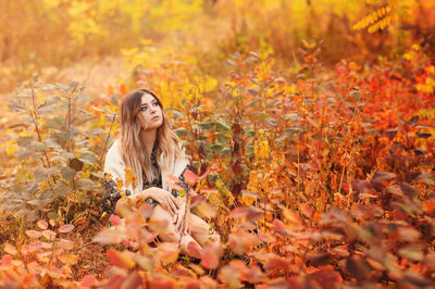 Young woman with yellow autumn leaves