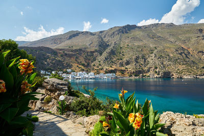 Scenic view of lake and mountains against sky