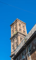 Low angle view of old building against clear blue sky