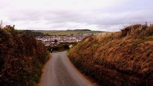 Road amidst landscape against sky