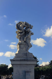 Low angle view of statue against cloudy sky