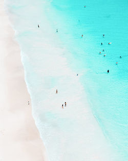 High angle view of people swimming in sea