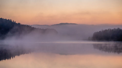 Scenic view of lake against sky during sunset