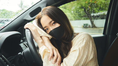 Portrait of woman sitting in car