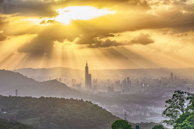 Aerial view of buildings in city during sunset