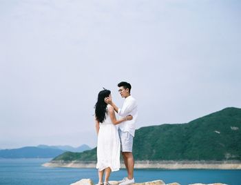 Rear view of woman standing on beach