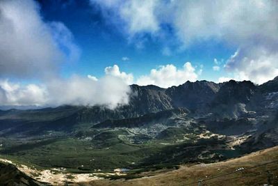 Scenic view of mountains against cloudy sky