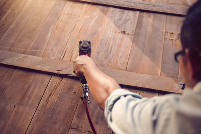 Carpenters using circular saw in workshop