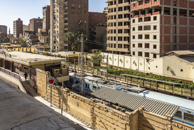 High angle view of railroad tracks amidst buildings in city