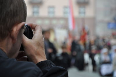 Rear view of man taking picture