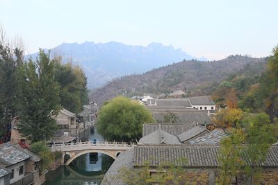 High angle view of river amidst buildings against sky