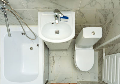 Top view of a small white bathroom. an example of a bathroom in a small apartment space.