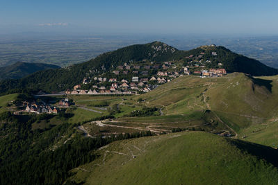 High angle view of houses on field by mountain