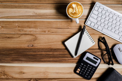 High angle view of coffee and laptop on table