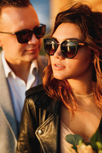 Portrait of a smiling young woman wearing sunglasses