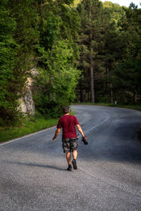 Mountain hiker photographer explores the area for the photographic hunting of wild animals. 