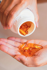 Cropped hand of woman holding pills