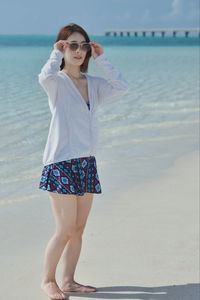 Young woman standing on beach