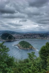High angle view of cityscape by sea against sky