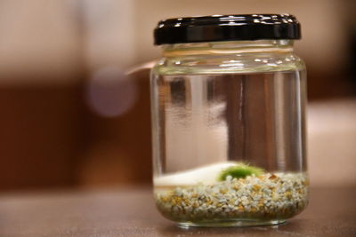 Close-up of glass jar on table