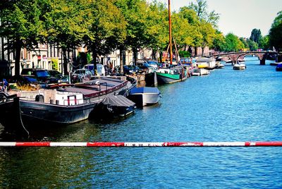 Boats in river with buildings in background