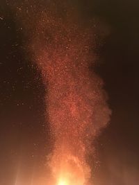 Low angle view of fireworks against sky at night