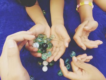 High angle view of hands holding people