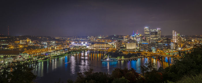 High angle view of city lit up at night