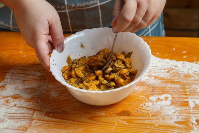 Cropped hand of person preparing food