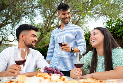 Happy young man drinking glasses on table