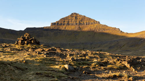 Rock formations on landscape against sky