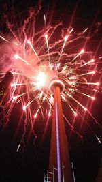 Low angle view of firework display at night