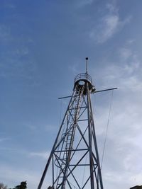 Low angle view of communications tower against sky