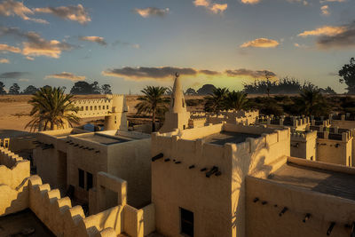 Buildings against sky during sunset