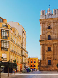 Buildings in city against clear sky