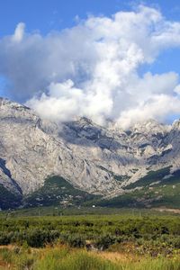 Scenic view of mountains against cloudy sky
