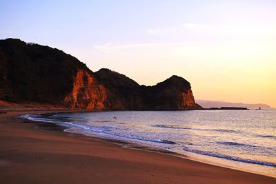 Scenic view of beach against sky during sunset