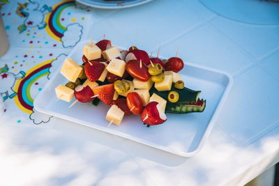 High angle view of chopped fruits in plate on table